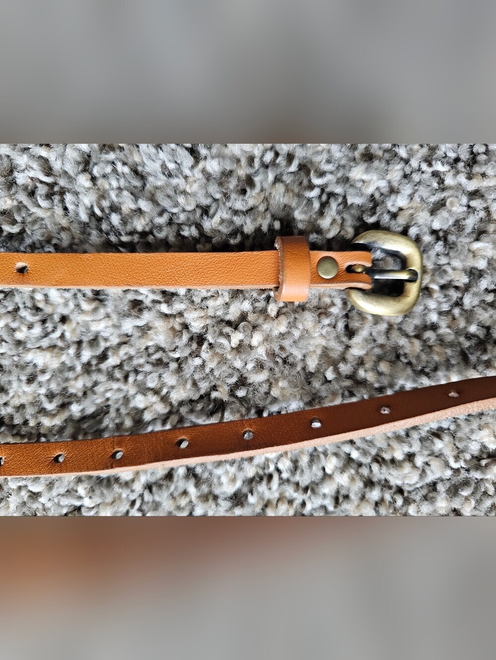skinn brown leather belts featuring a brass-colored metal buckwith Brass Buckle